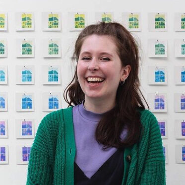 Gemma smiling in front of lots of small illustrations of windows